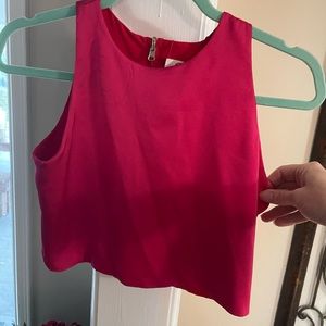 A two piece top and asymmetrical skirt. The top reverses to red or pink.